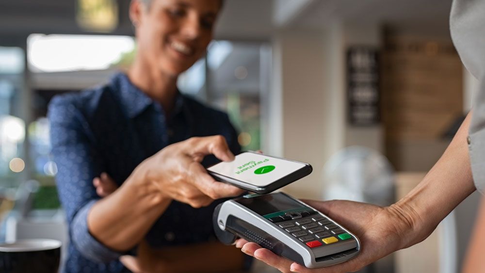 Customer paying at point of sale with smartphone